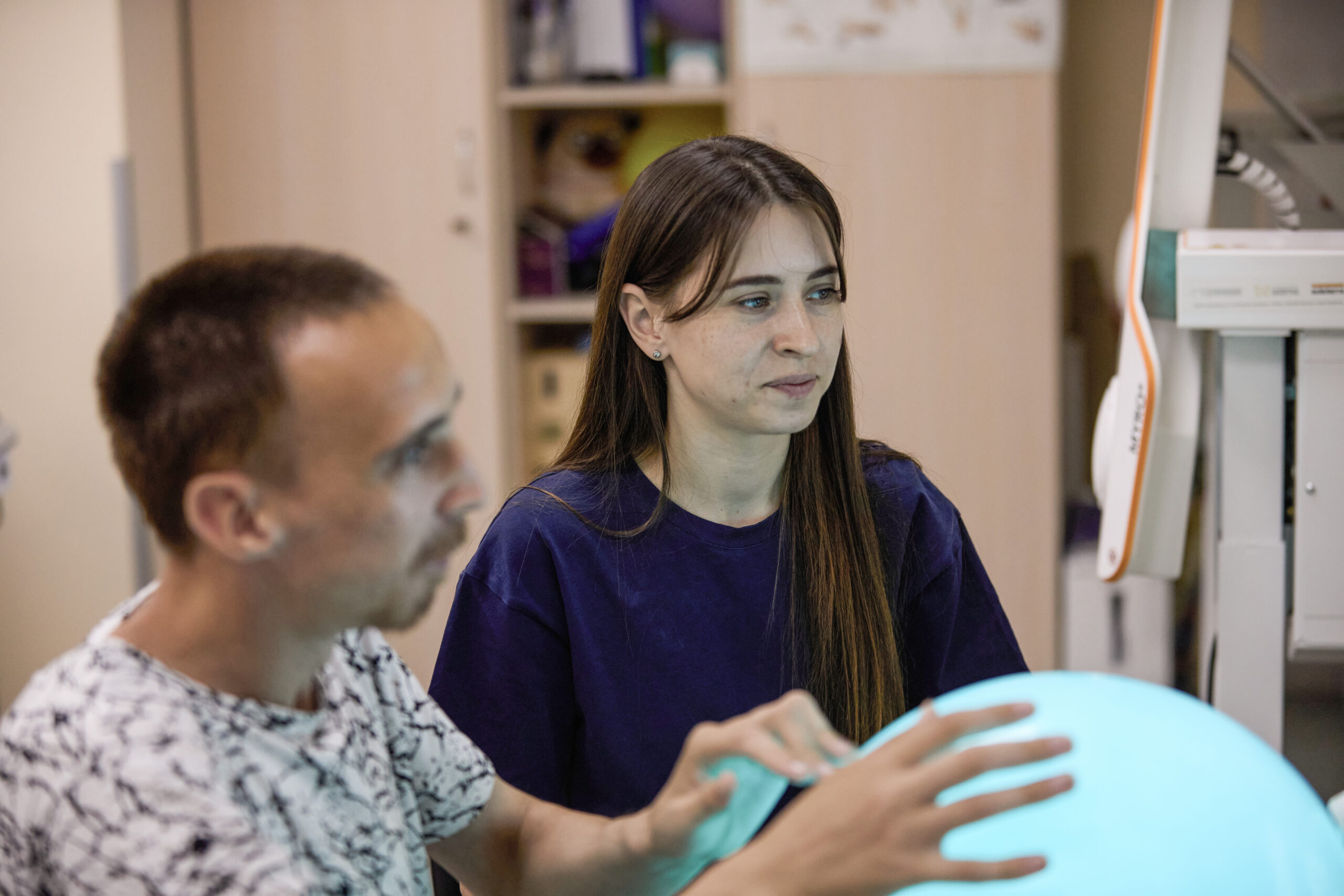 An occupational therapist assisting a rehabilitation exercise